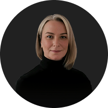 Portrait of a confident woman with blonde hair in professional black attire