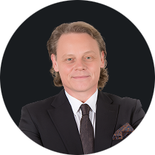 Business professional wearing suit and tie with a confident smile