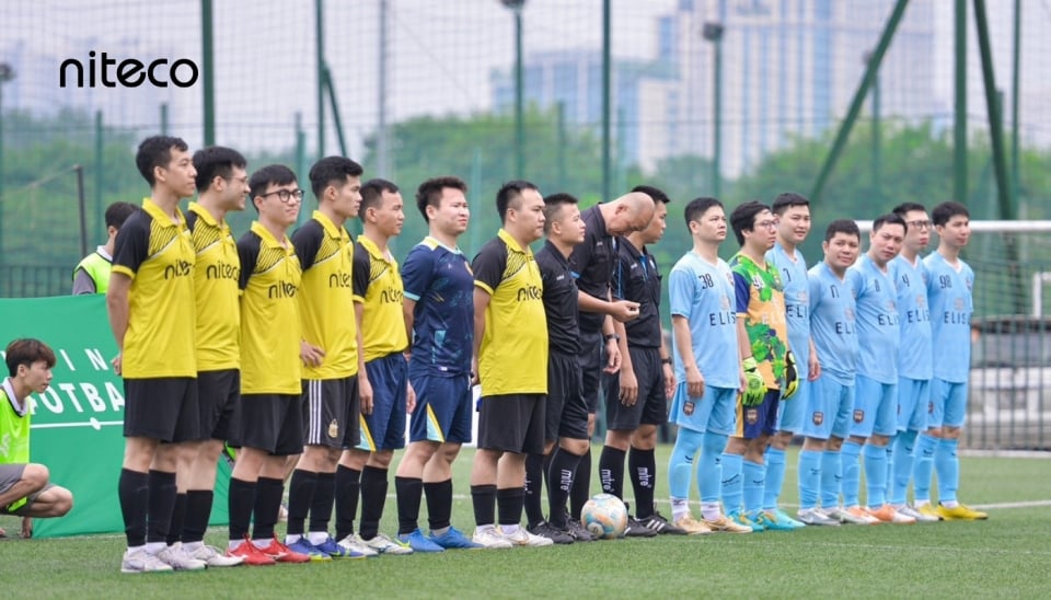 Niteco football teams in yellow and blue uniforms lined up on the field