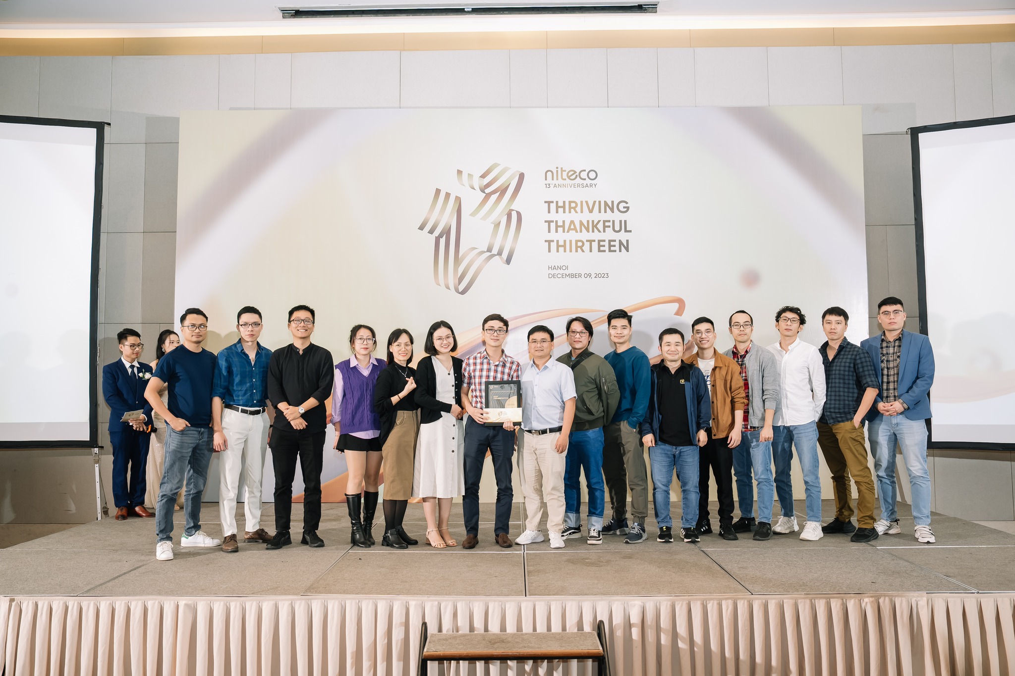 Niteco 13th anniversary team celebration with group holding award in Hanoi 2023