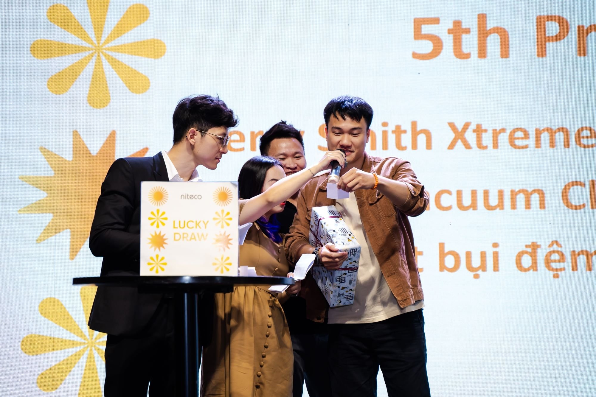 Employee smiling while holding lucky draw prize