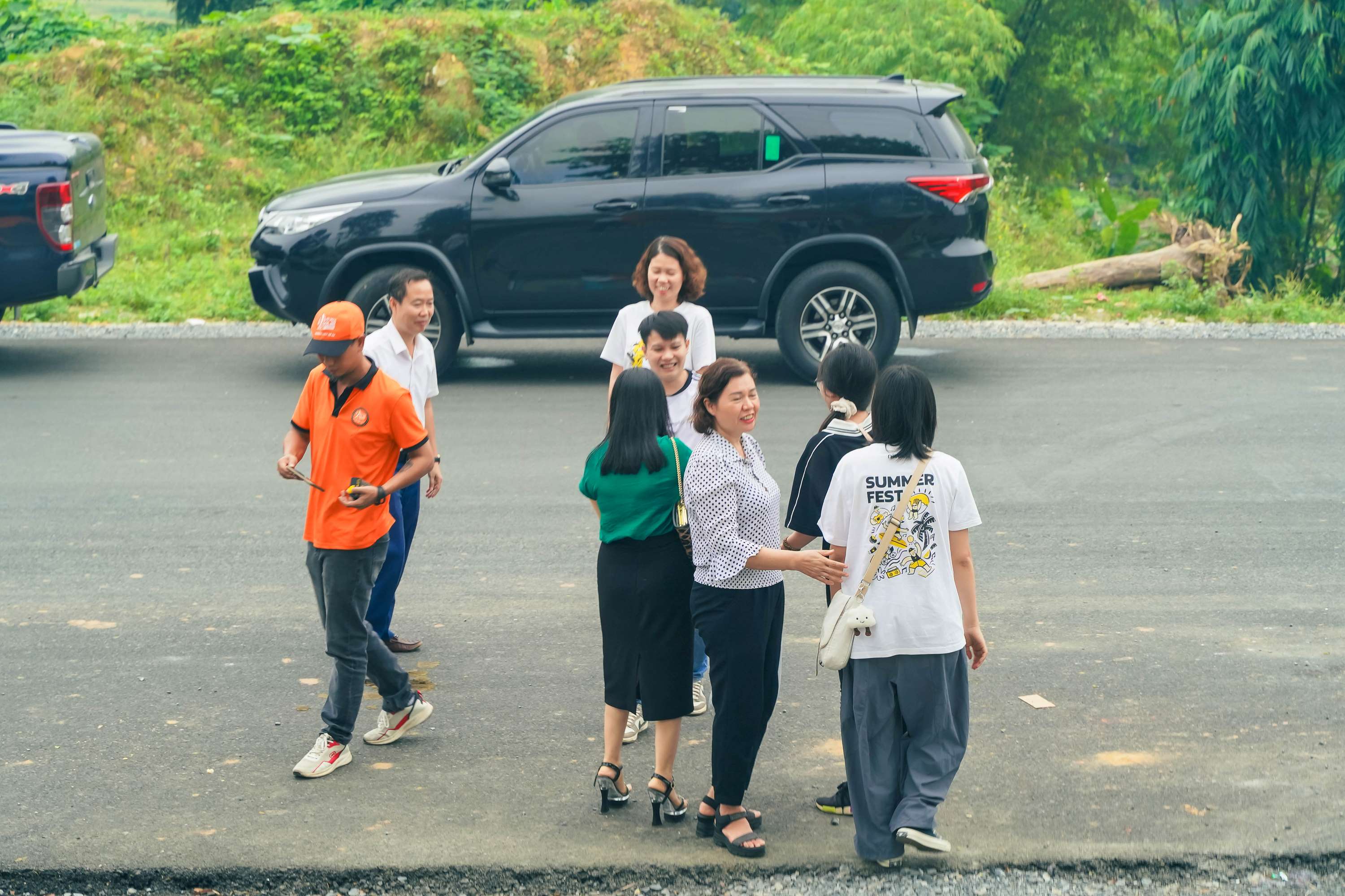 Volunteers standing in front of the school building