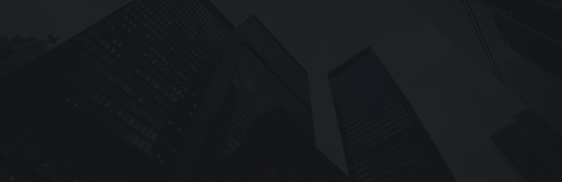 Skyscrapers at night showcasing modern corporate office buildings and glass facades
