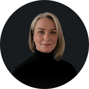 Professional headshot of a confident woman with blonde hair in black turtleneck