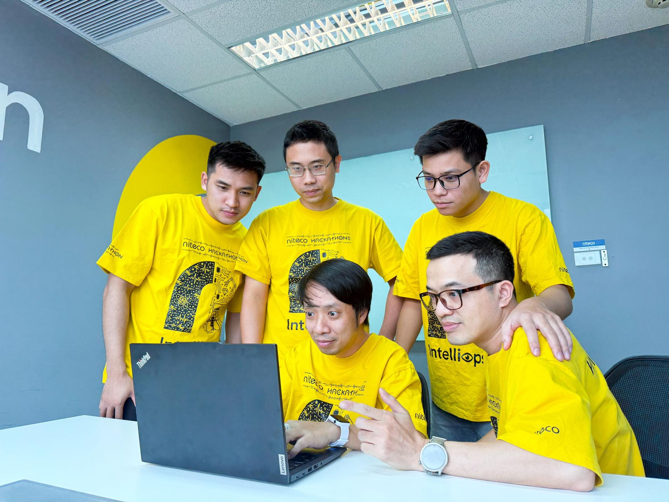 IntelliOps team reviewing their AI operations solution during the Niteco AI Hackathon 2026