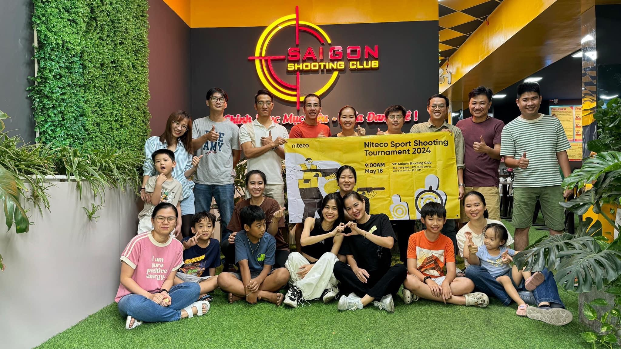 Group at Saigon Shooting Club holding banner for Niteco Sport Shooting Tournament 2024