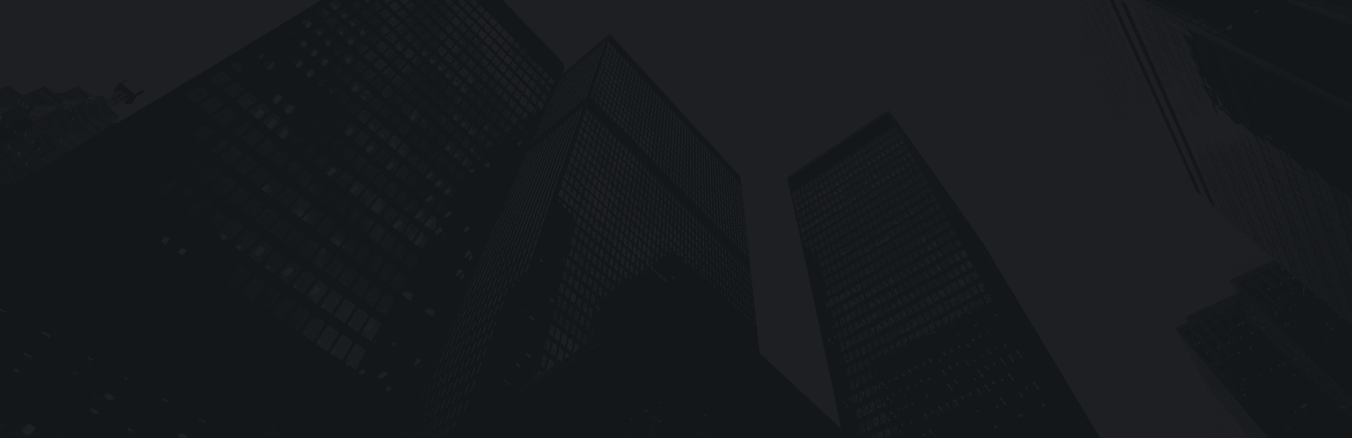 Skyscrapers with modern glass windows towering in a city skyline at dusk