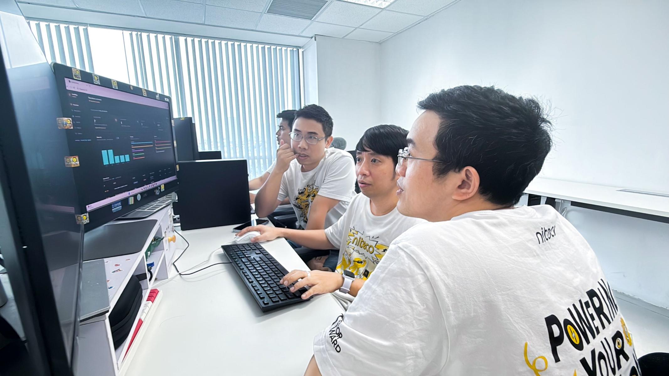 IntelliOps team analysing system data while developing their AI-powered operations platform