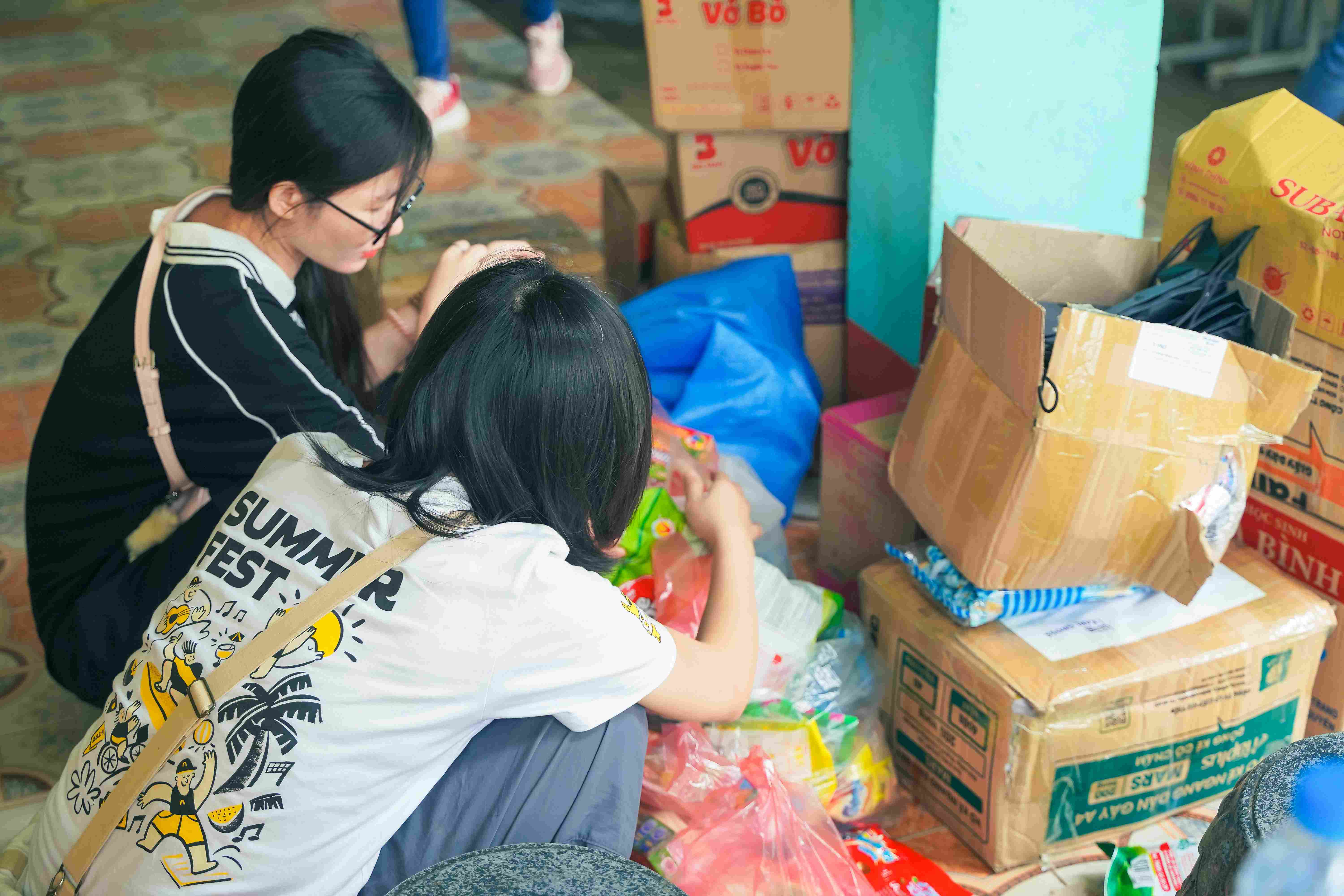 Volunteers unloading donations in schoolyard
