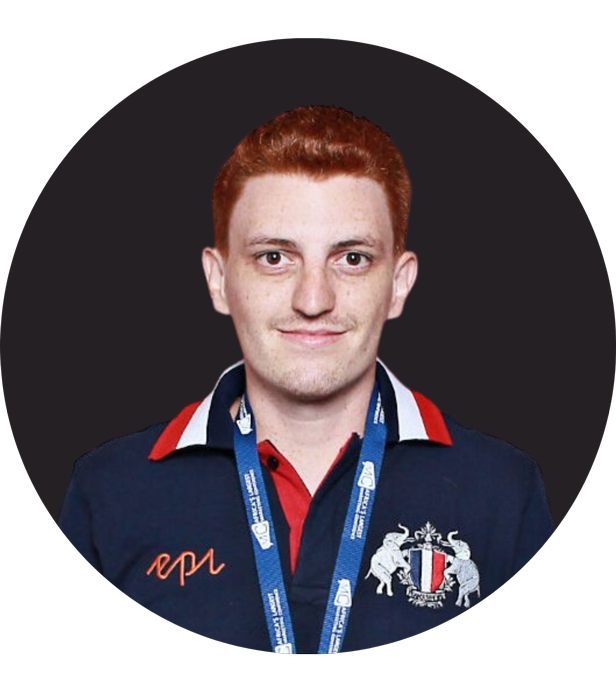 Red-haired man wearing a navy polo with emblem and conference lanyard