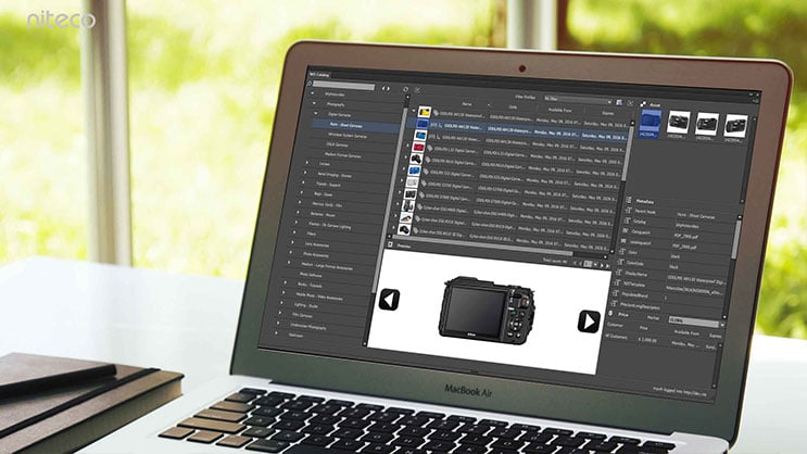 Laptop screen displaying photo management software with camera images and metadata