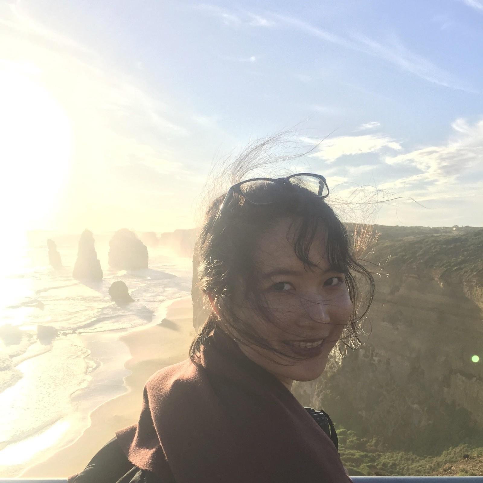 Sunset at Twelve Apostles with a woman enjoying the scenic coastal view